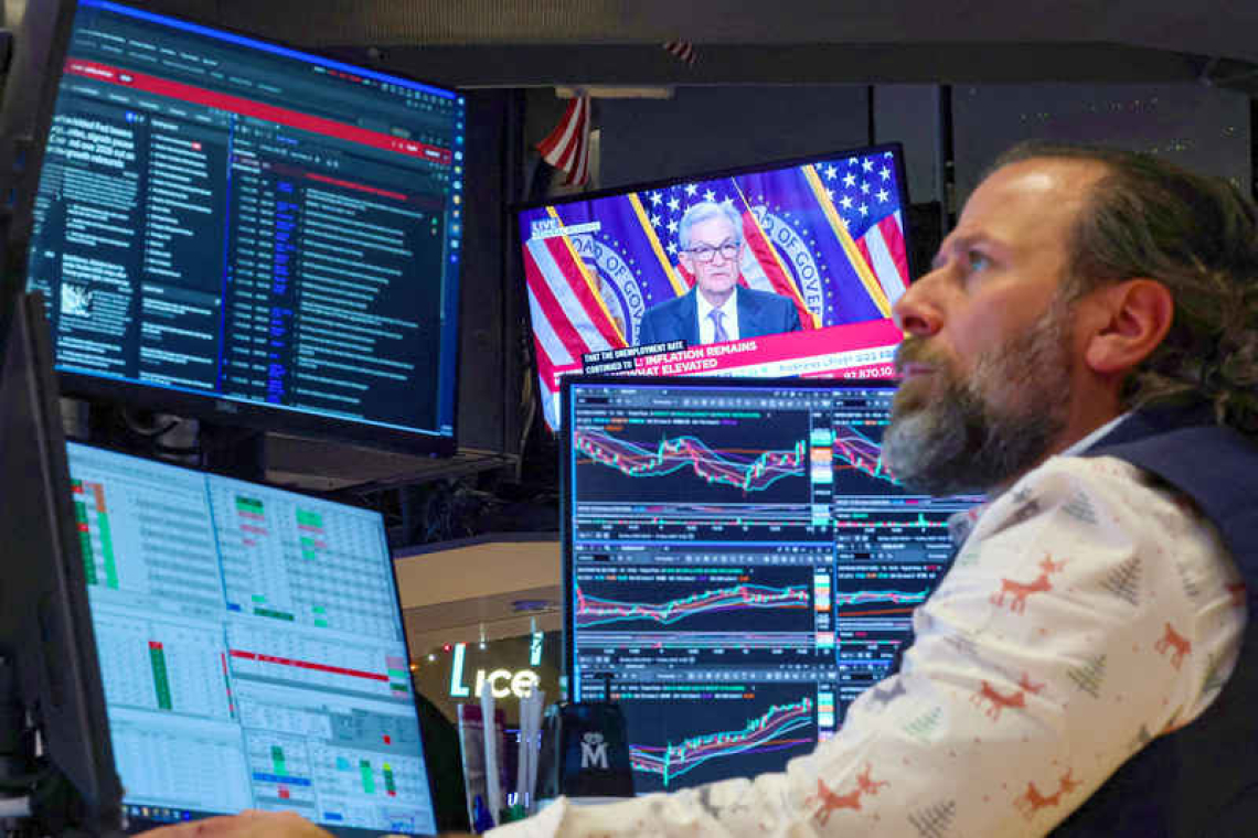 Divided Fed lowers  rates, signals pause